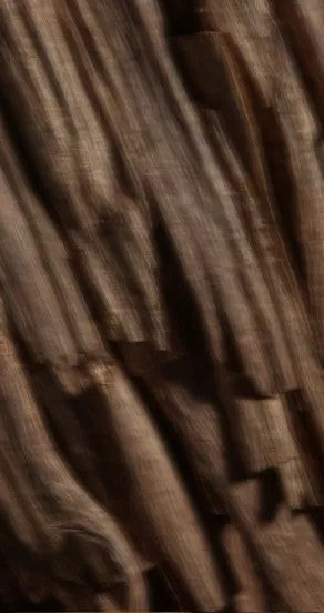 nights in morocco perfume oil bottle with warm amber glow on a textured desert surface