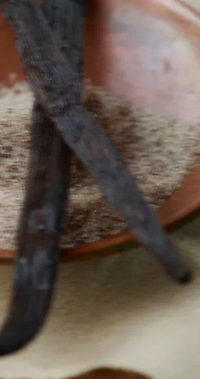 under the sheets hand cream tube with saffron and tobacco notes on a warm, sunlit surface