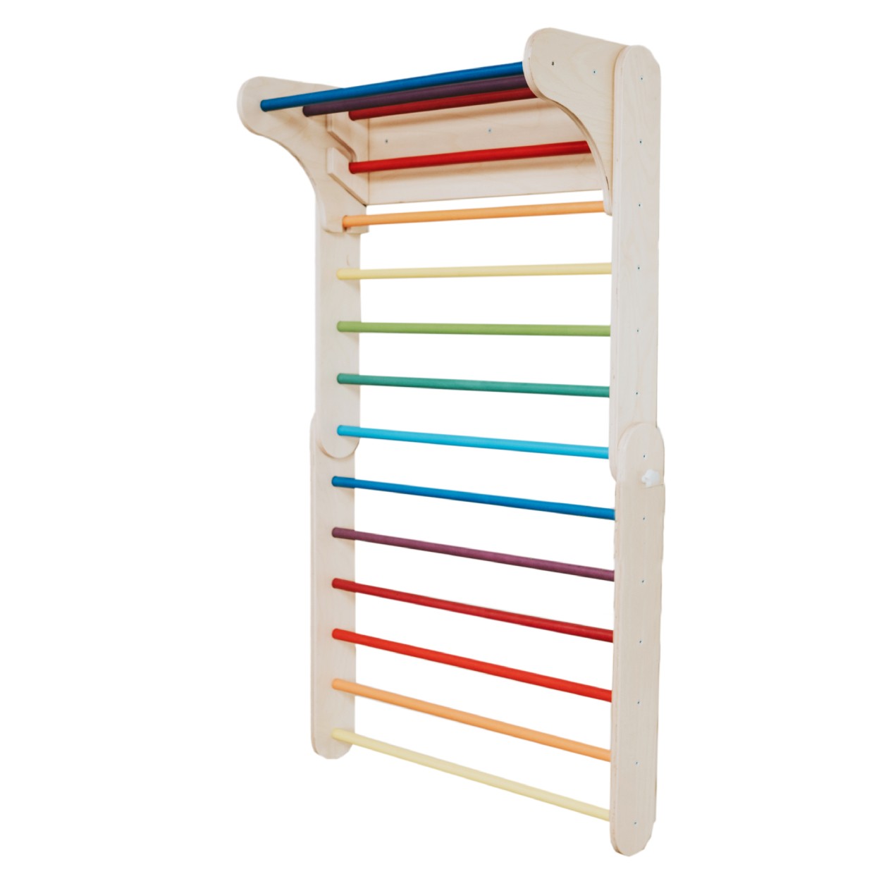 a child's hand reaching for the top of the rainbow climber in warm morning light