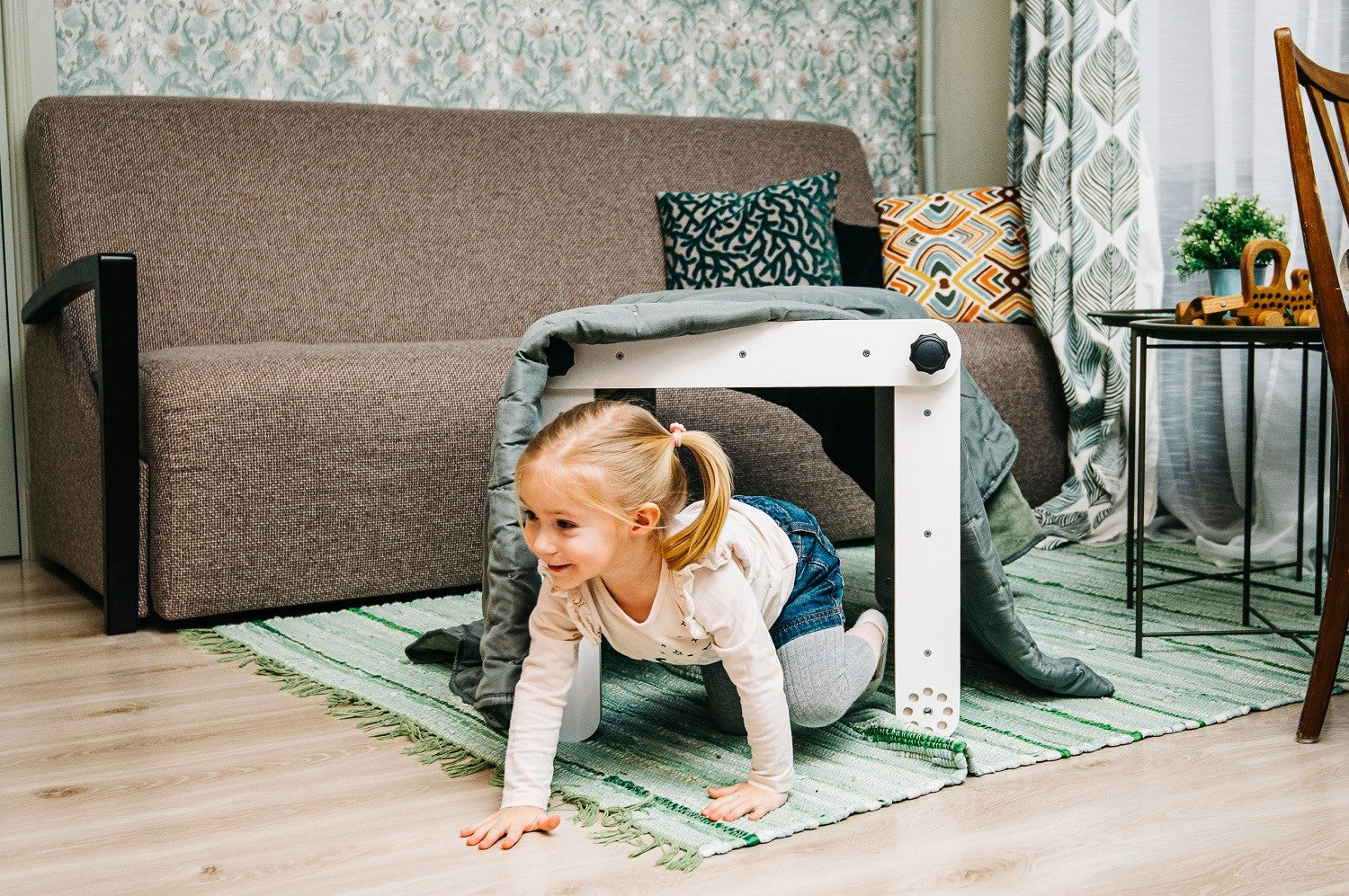 pikler triangle in a cozy nursery corner with soft morning light