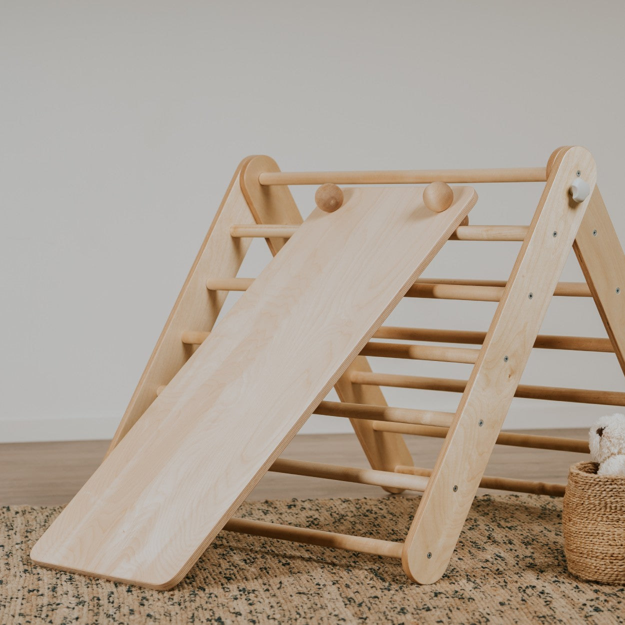 a functional close-up of the climbing ramp's textured rock holds and birch plywood construction