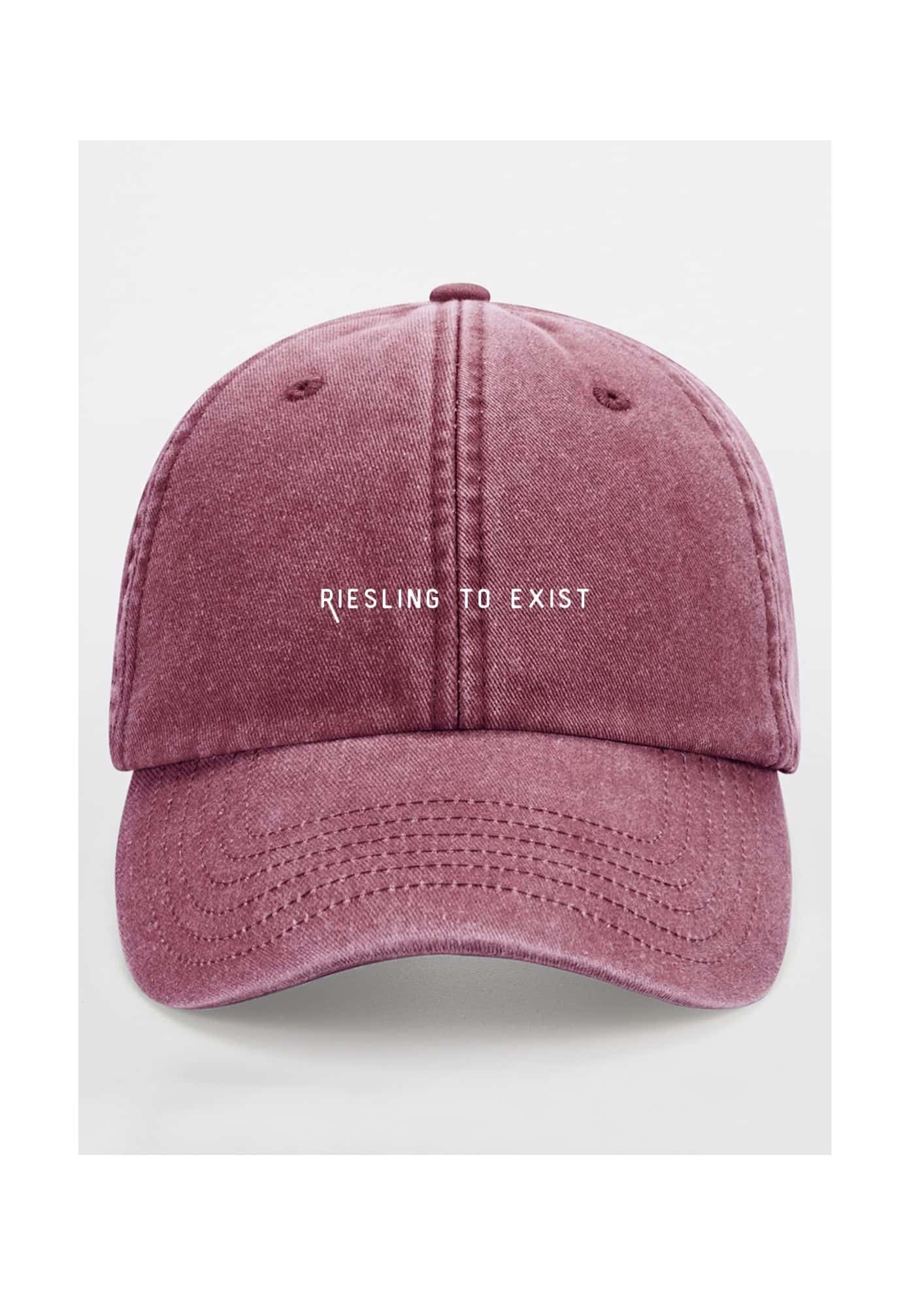 a soft cotton cap with the riesling to exist slogan in warm, gentle light