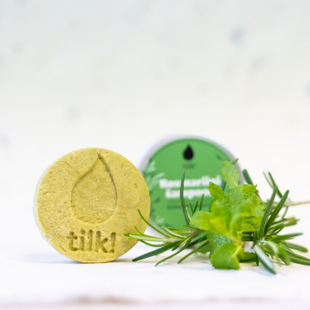 bold green matcha shampoo bar with fresh mint leaves on a dark slate background