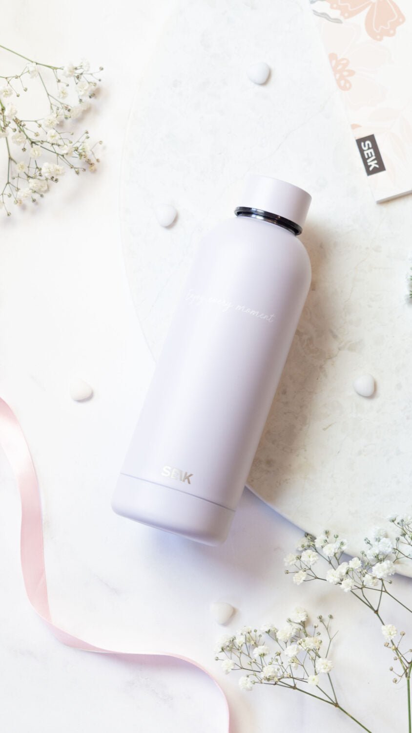 elegant lilac thermos on a marble surface with soft morning light