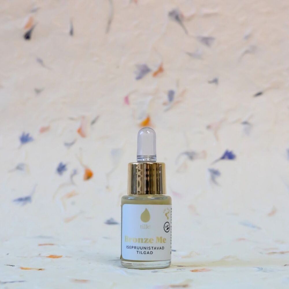 bold close-up of self-tanning drops with algae extract and hyaluronic acid, glowing in golden light