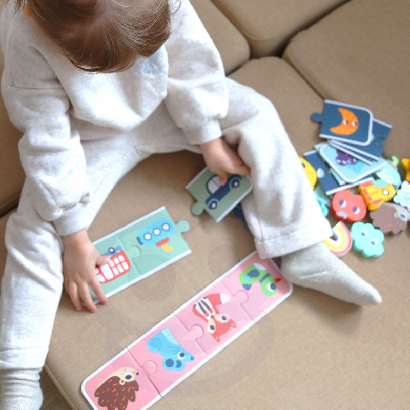 a child's hands gently feeling the smooth wooden shapes of the sensory memory puzzle