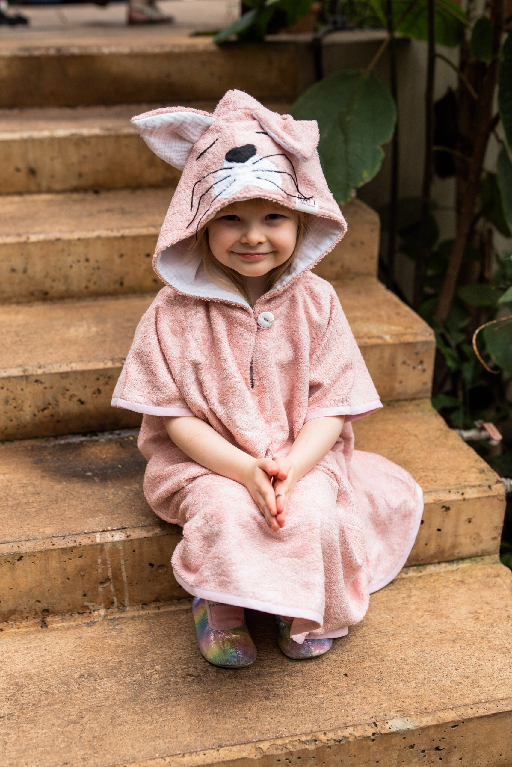 bold kids poncho with cat hood in morning light - confident style for young explorers