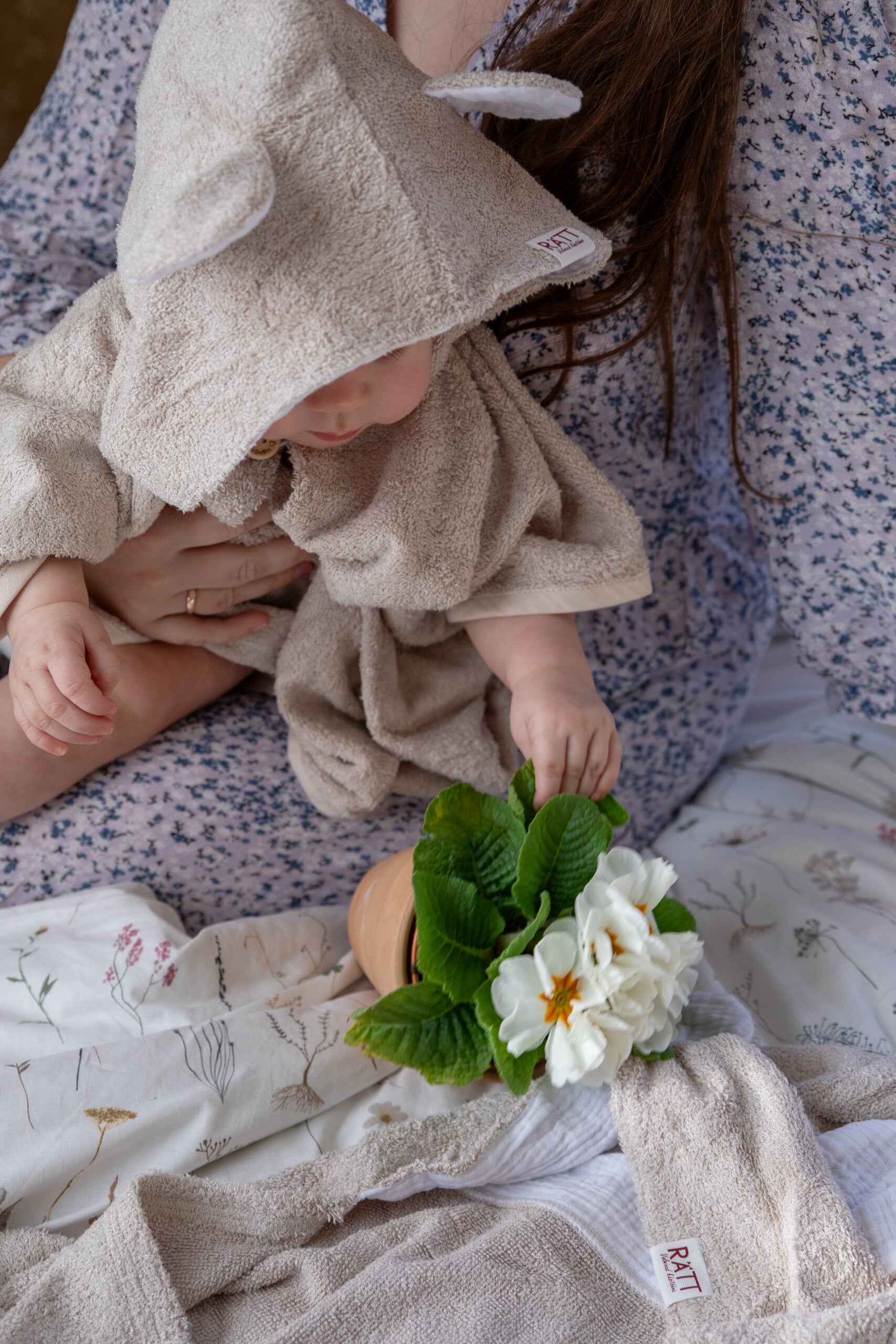 toddler in cozy bamboo poncho showing practical side pockets and short sleeves