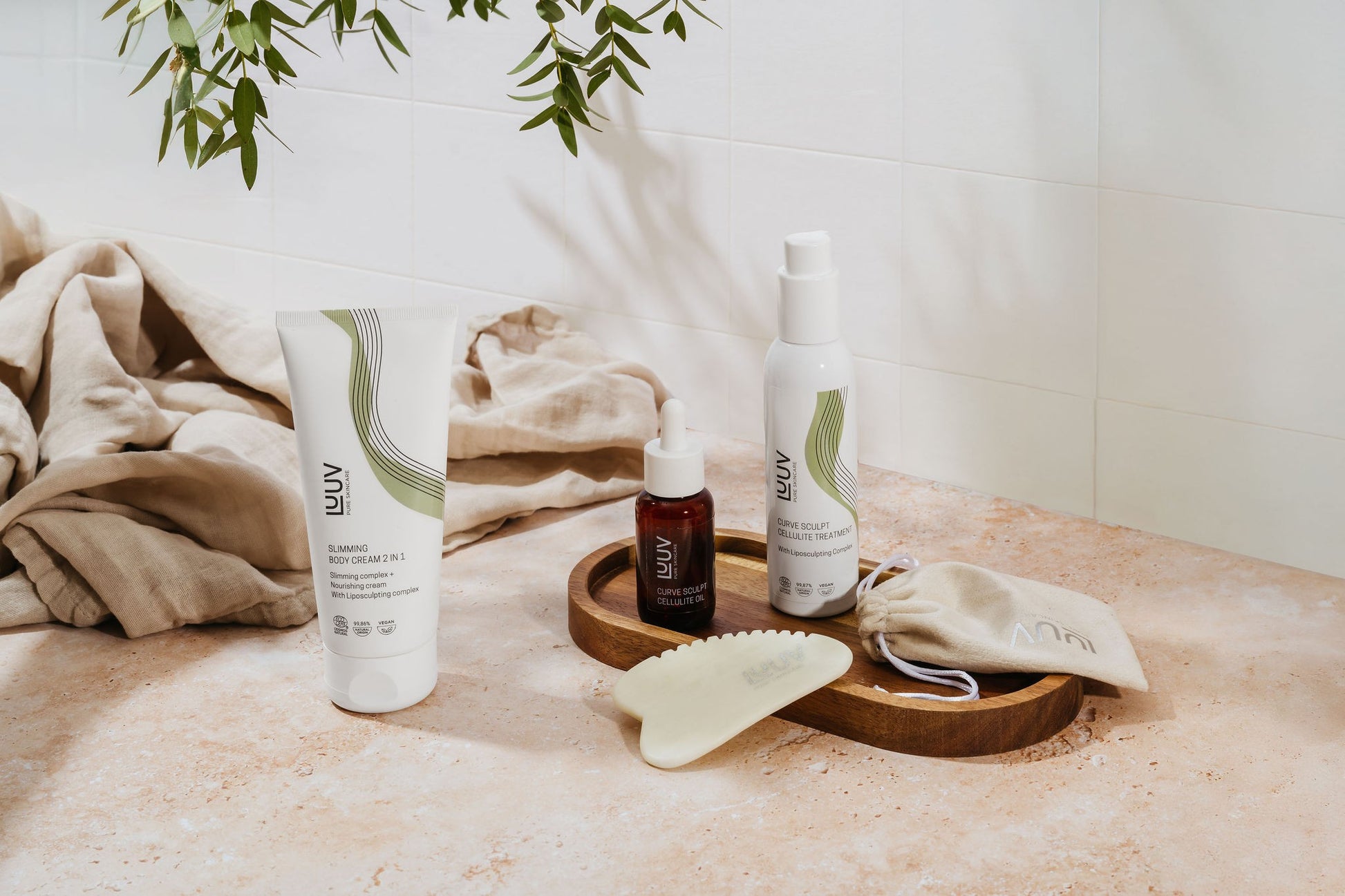 playful close-up of nourishing slimming cream being scooped, fresh eucalyptus scent