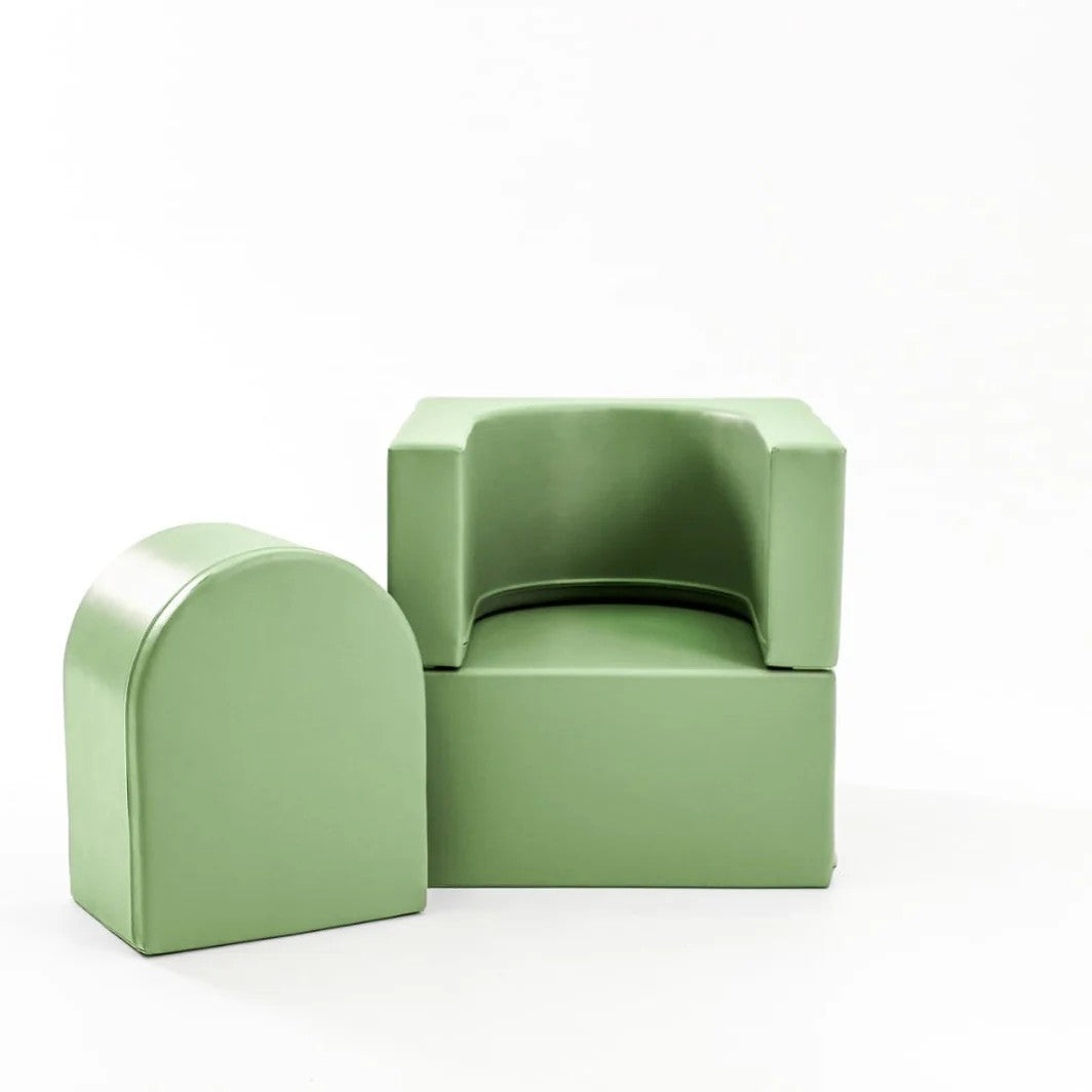 bold bright green kids lounger in a modern playroom with dramatic side lighting