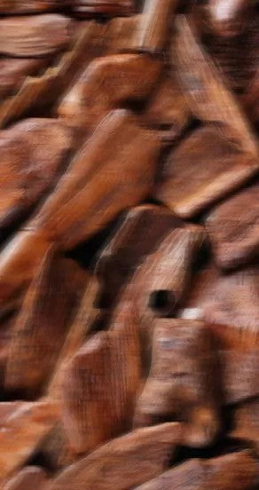 temple of sensus perfume bottle on a warm leather surface with soft smoke and incense