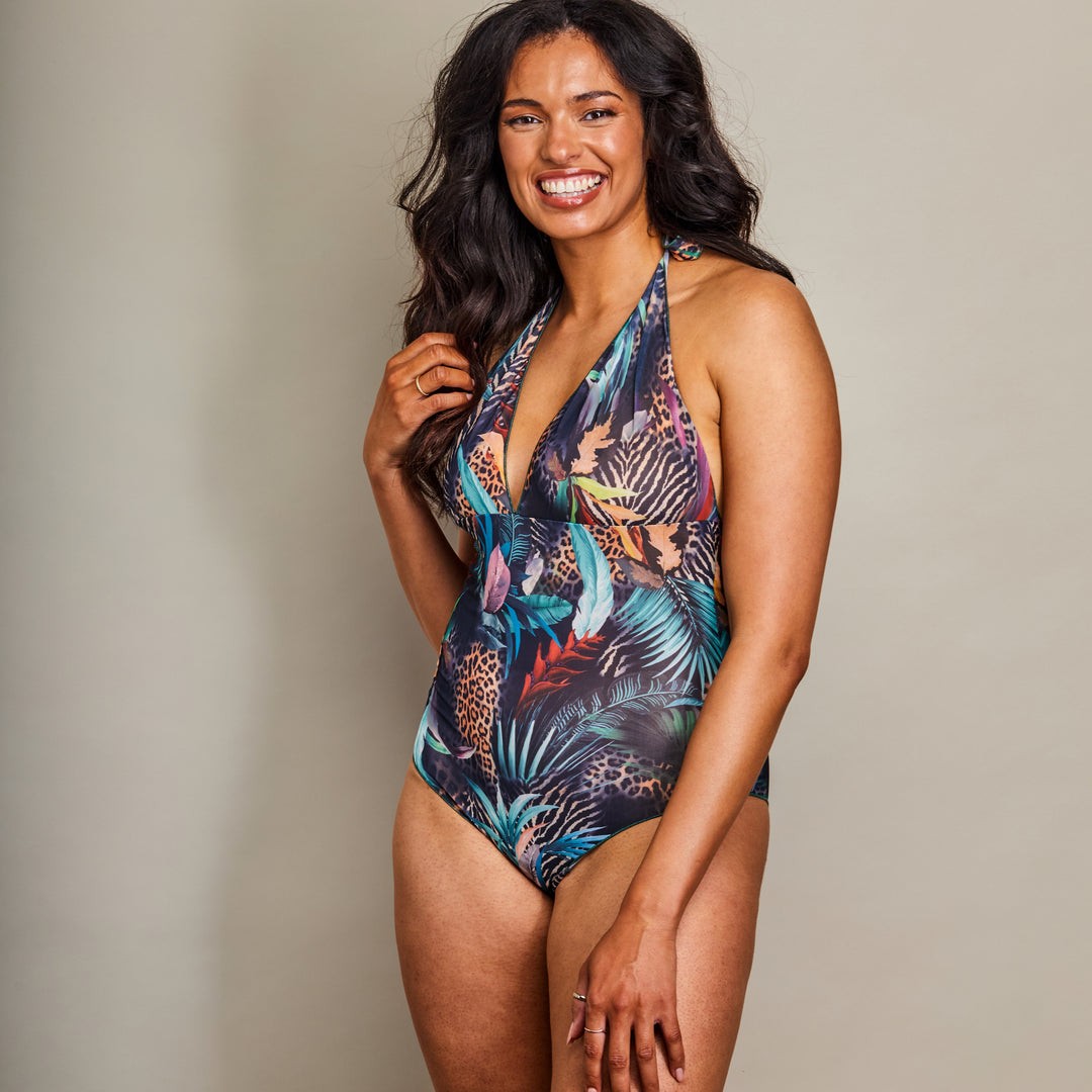 bold tan-through halterneck swimsuit in sunlight, highlighting adjustable straps and modest coverage