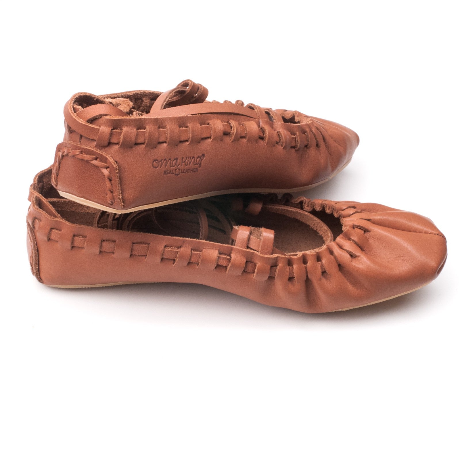 softly lit elegant tied leather dancing shoes on a cozy textile bag