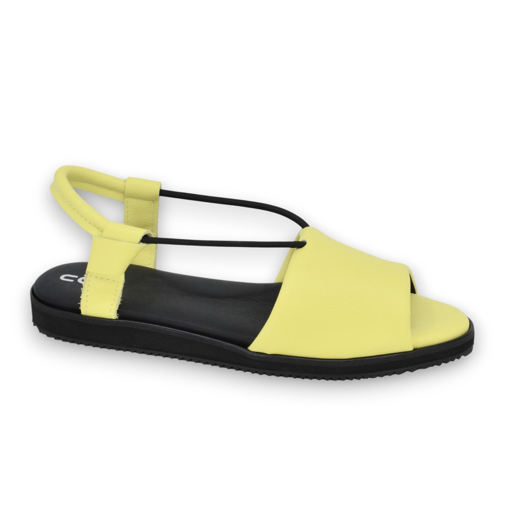 playful close-up of vibrant lime yellow leather sandals on a sunny summer day
