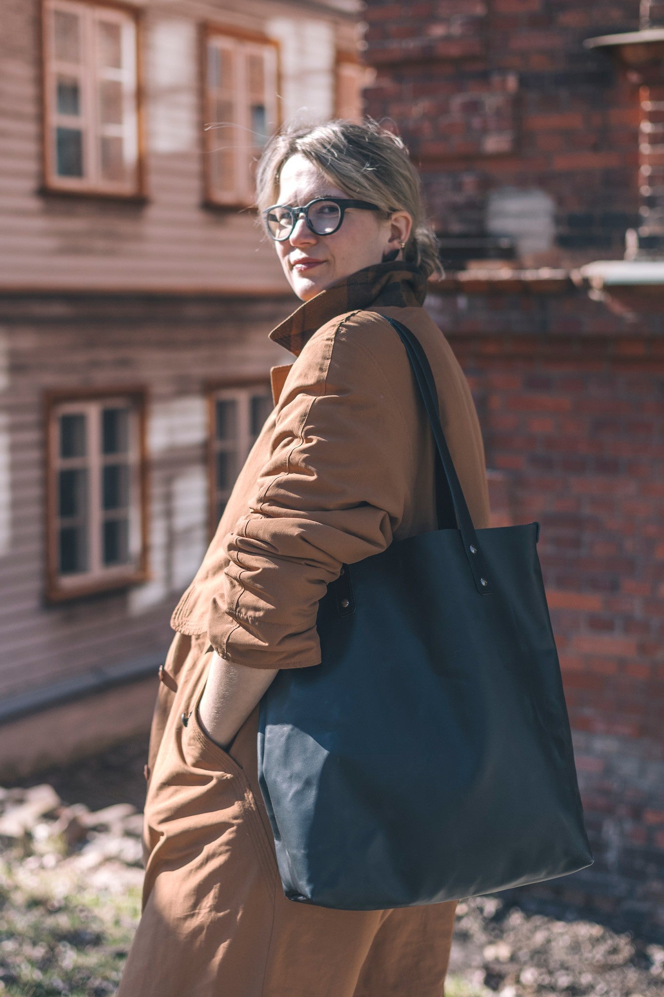 a playful close-up of the island hopper tote with a scarf and book peeking out