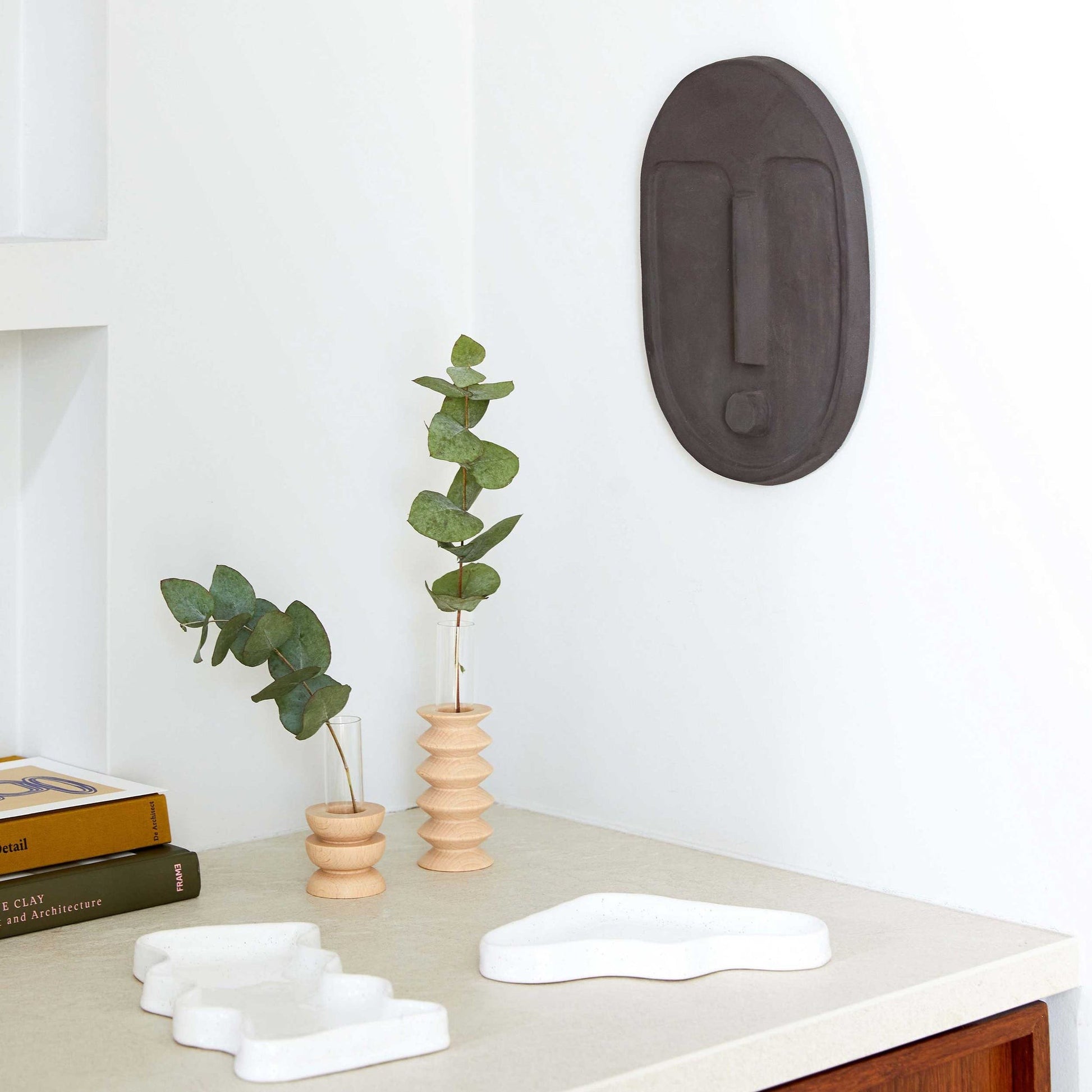 playful short totem vase with a bright bouquet on a sunny windowsill