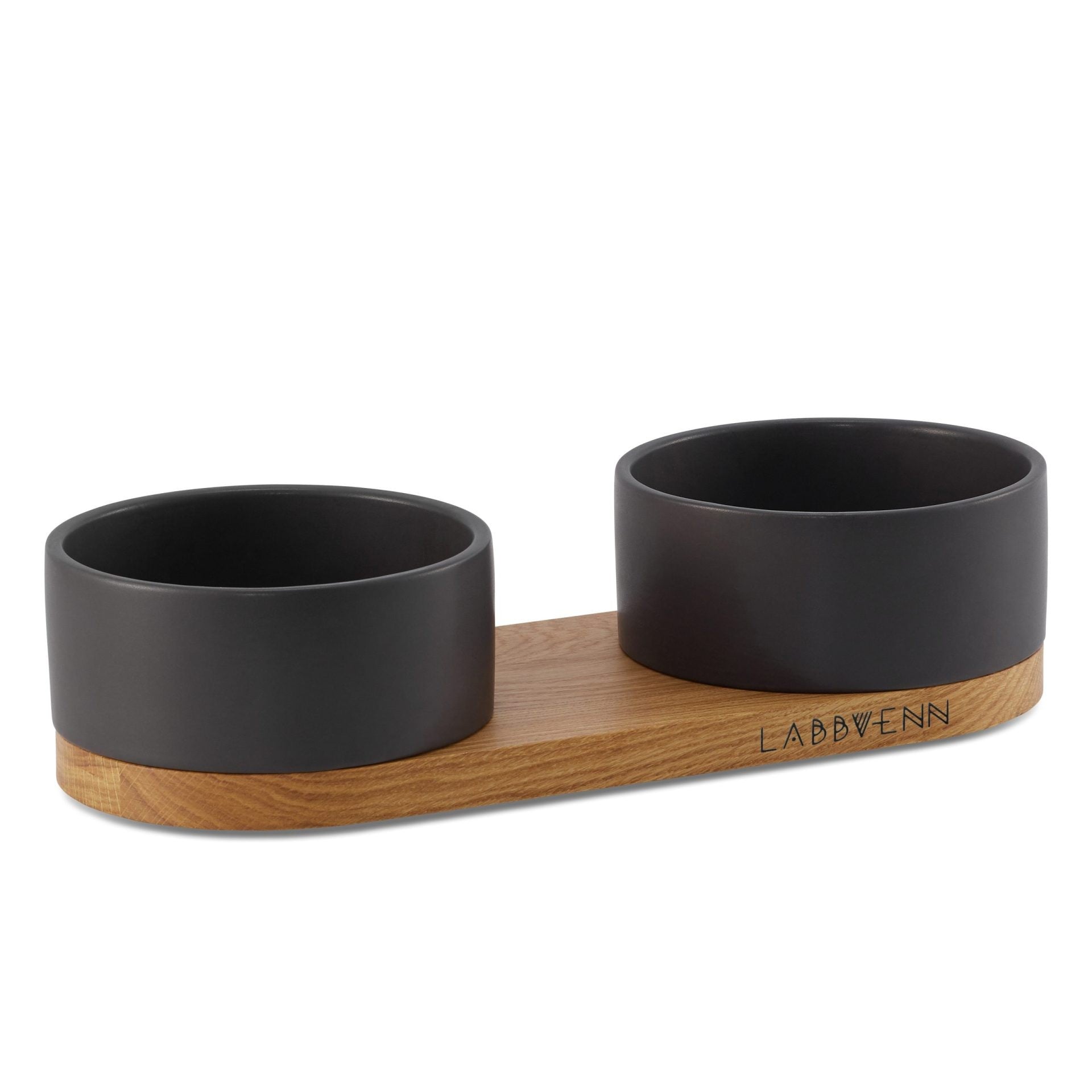 bold black ceramic pet feeder with oak base in dramatic studio lighting