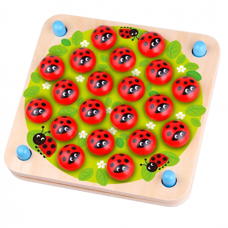 soft-lit close-up of a child's hands holding the ladybug memory puzzle