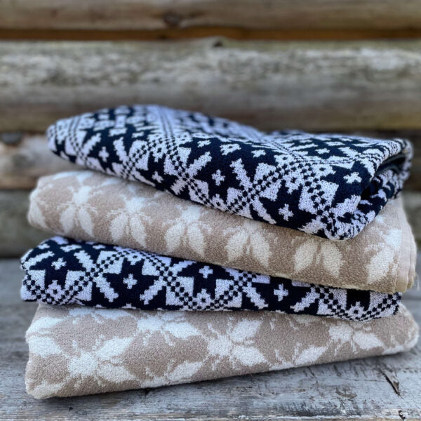 "Handcrafted Estonian textiles and wooden cutting boards by Loko, showcasing traditional knitting patterns and sustainable craftsmanship."