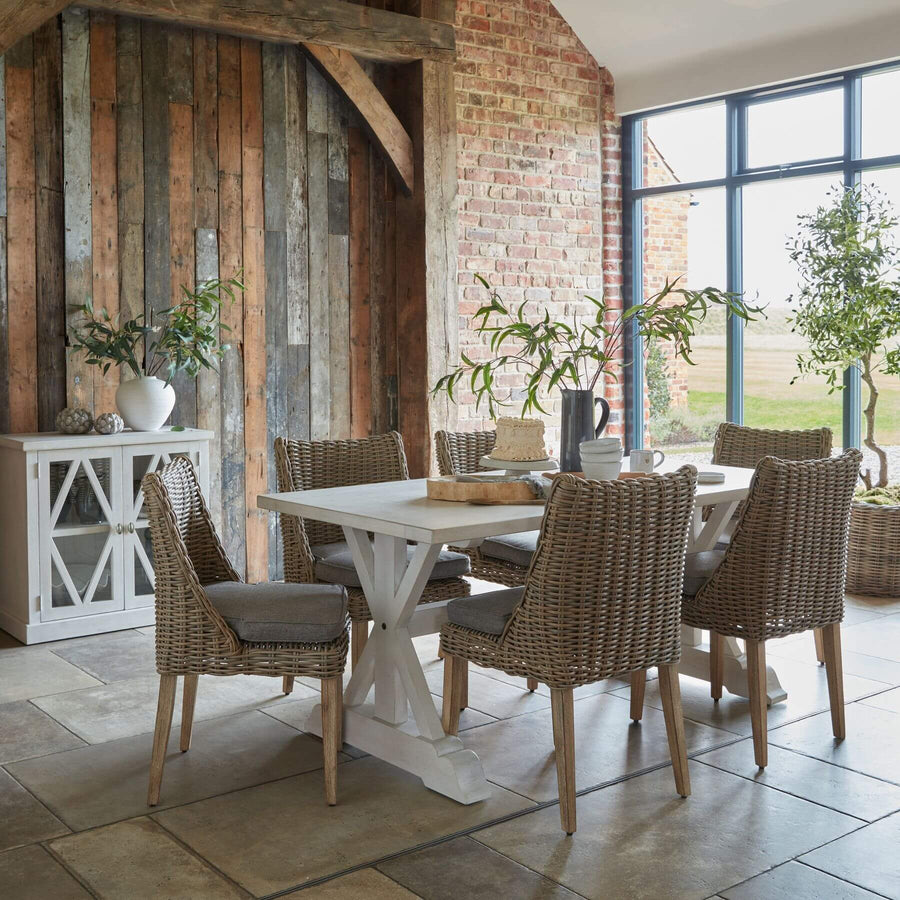Handwoven beige outdoor dining chair with HDPE wicker and powder-coated aluminum frame, Mediterranean style. by Hill Interiors at brixbailey.com