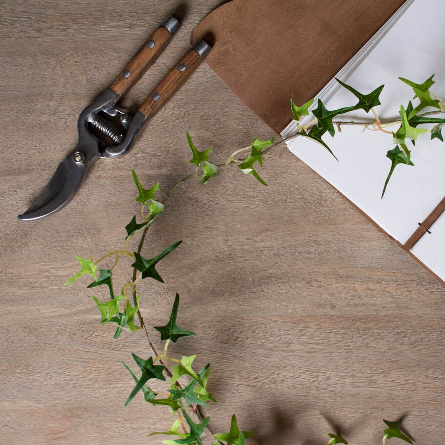 Lifelike artificial ivy garland with realistic green foliage, perfect for shelves, mantels, or table decor by Sostter at brixbailey.com