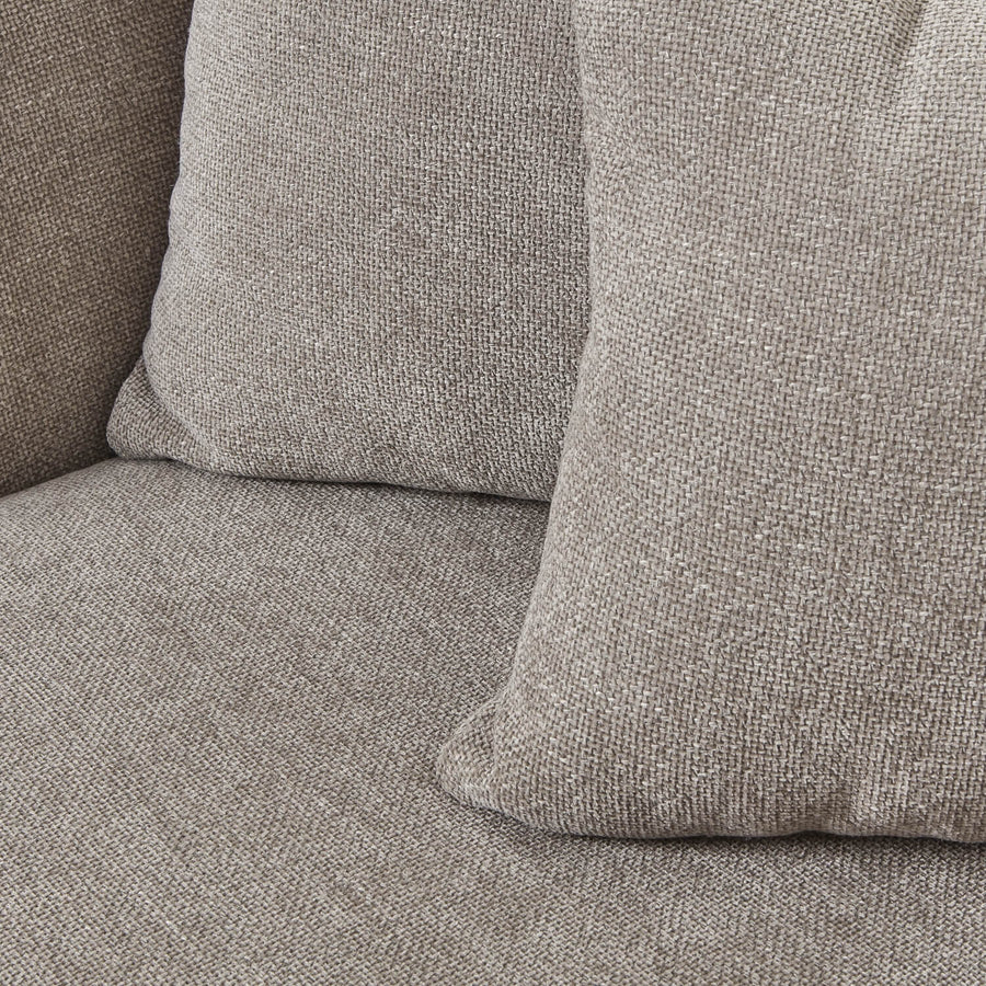 Taupe snuggle chair with plush cushioning and solid wood frame for cozy relaxation in modern decor by Sostter at brixbailey.com