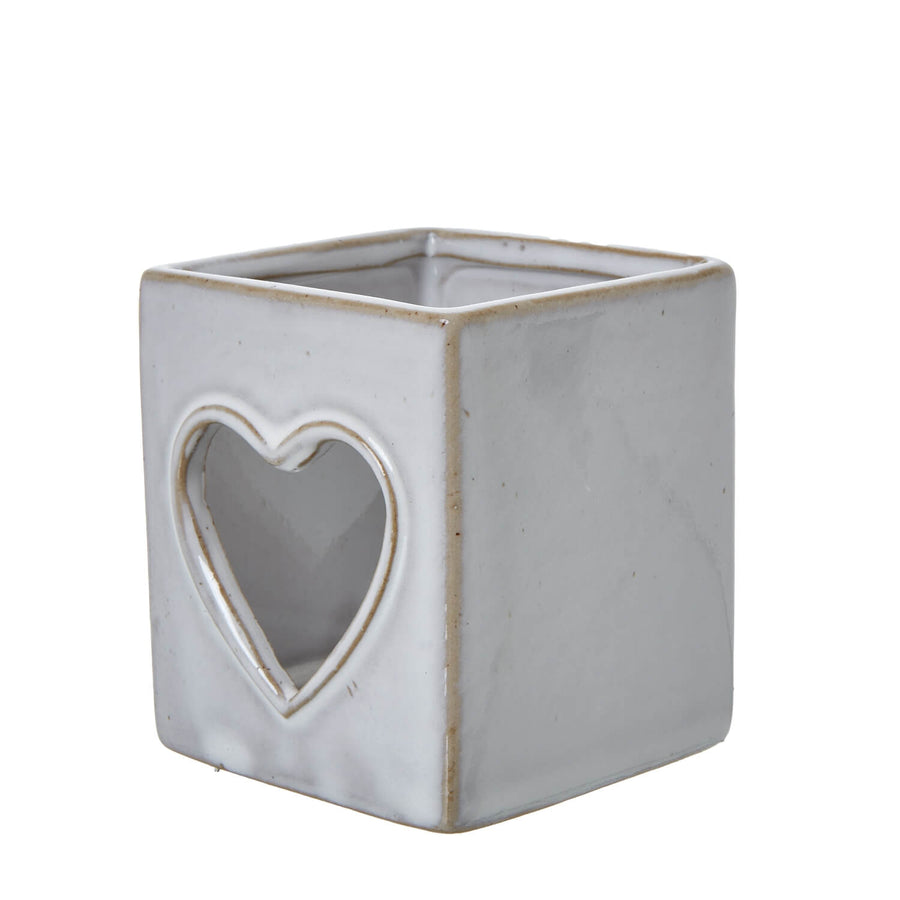 White ceramic tealight holder with heart cutout, Scandinavian design, creates enchanting light patterns by Hill Interiors at brixbailey.com