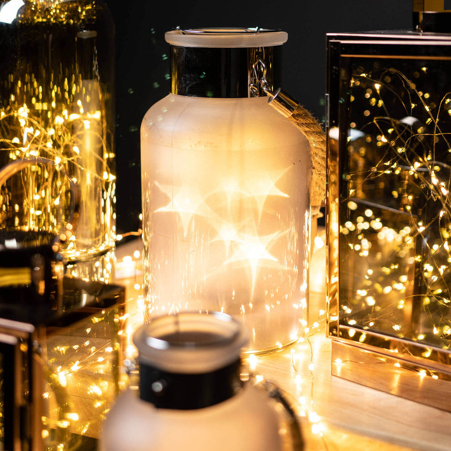 Frosted grey glass lantern with LED starlight glow, rope handle, rustic modern design for indoor or outdoor decor. by Sostter at brixbailey.com
