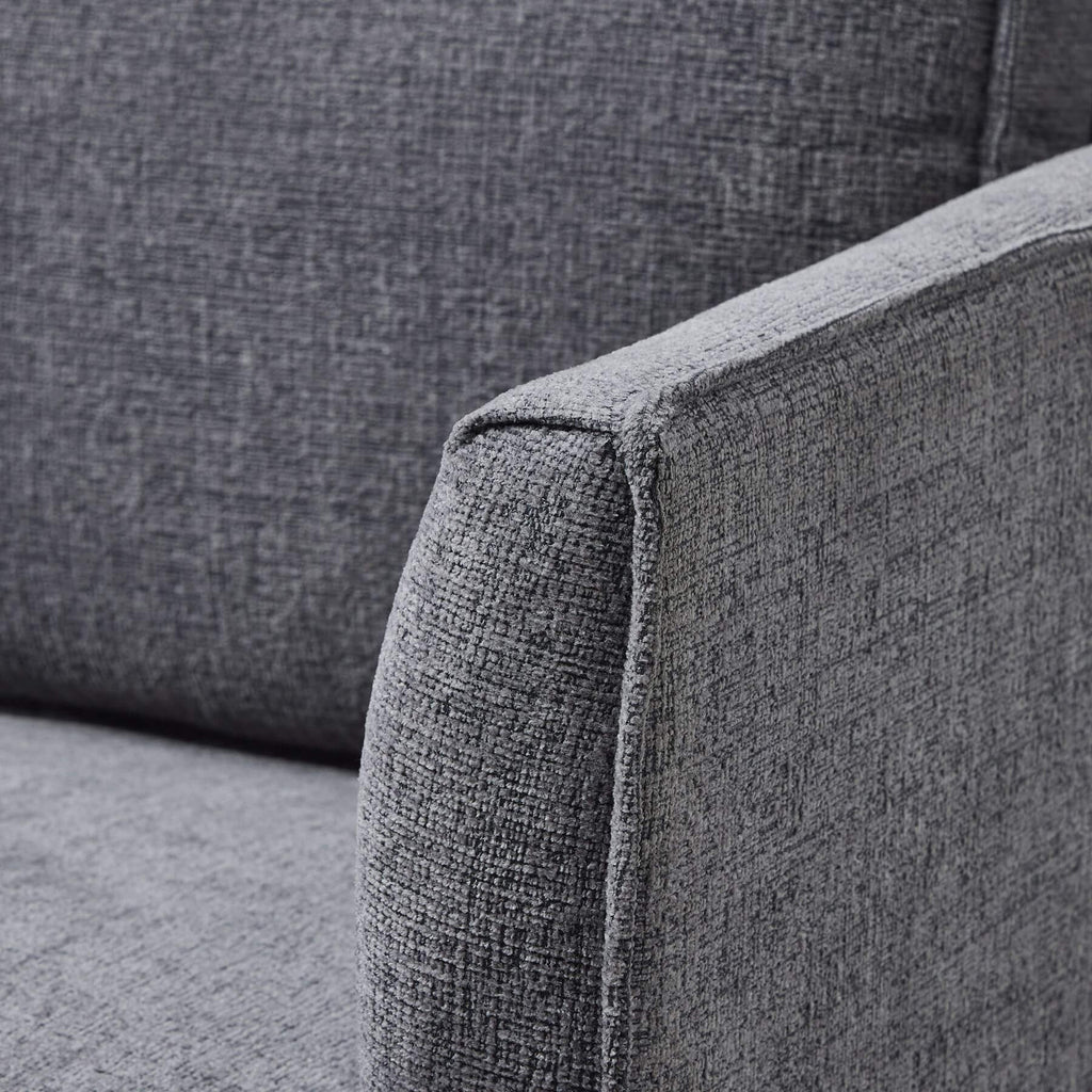 Grey fabric armchair with curved arms, modern design, and plush upholstery for stylish living room seating by Sostter at brixbailey.com