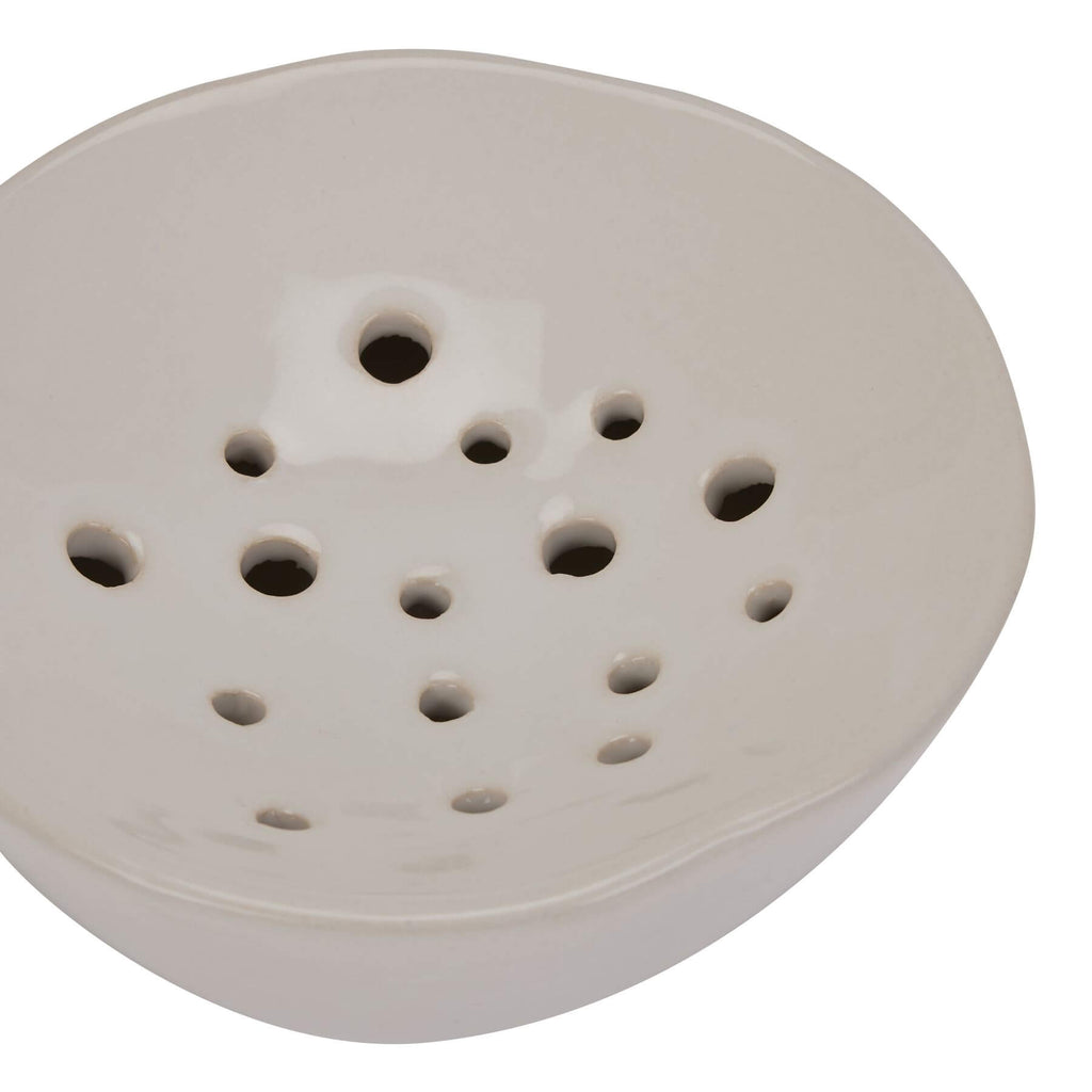 Handcrafted ceramic flower frog in classic off-white, with glazed finish and precision holes for floral arrangements. by Sostter at brixbailey.com