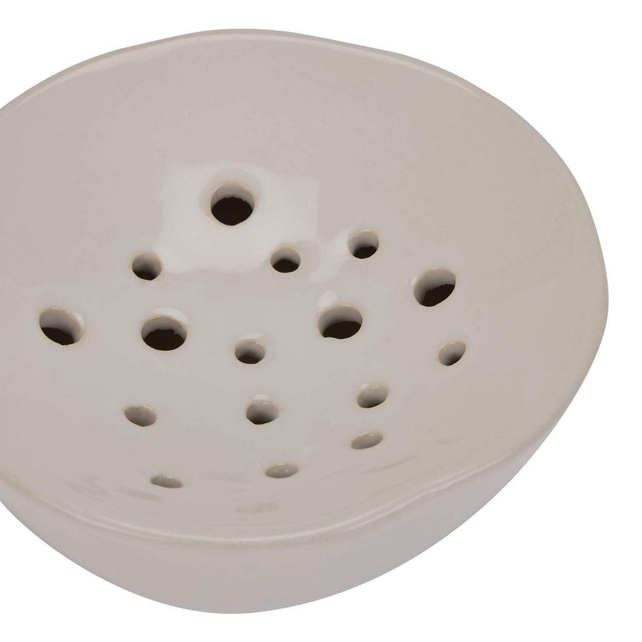 Handcrafted ceramic flower frog in classic off-white, with glazed finish and precision holes for floral arrangements. by Sostter at brixbailey.com