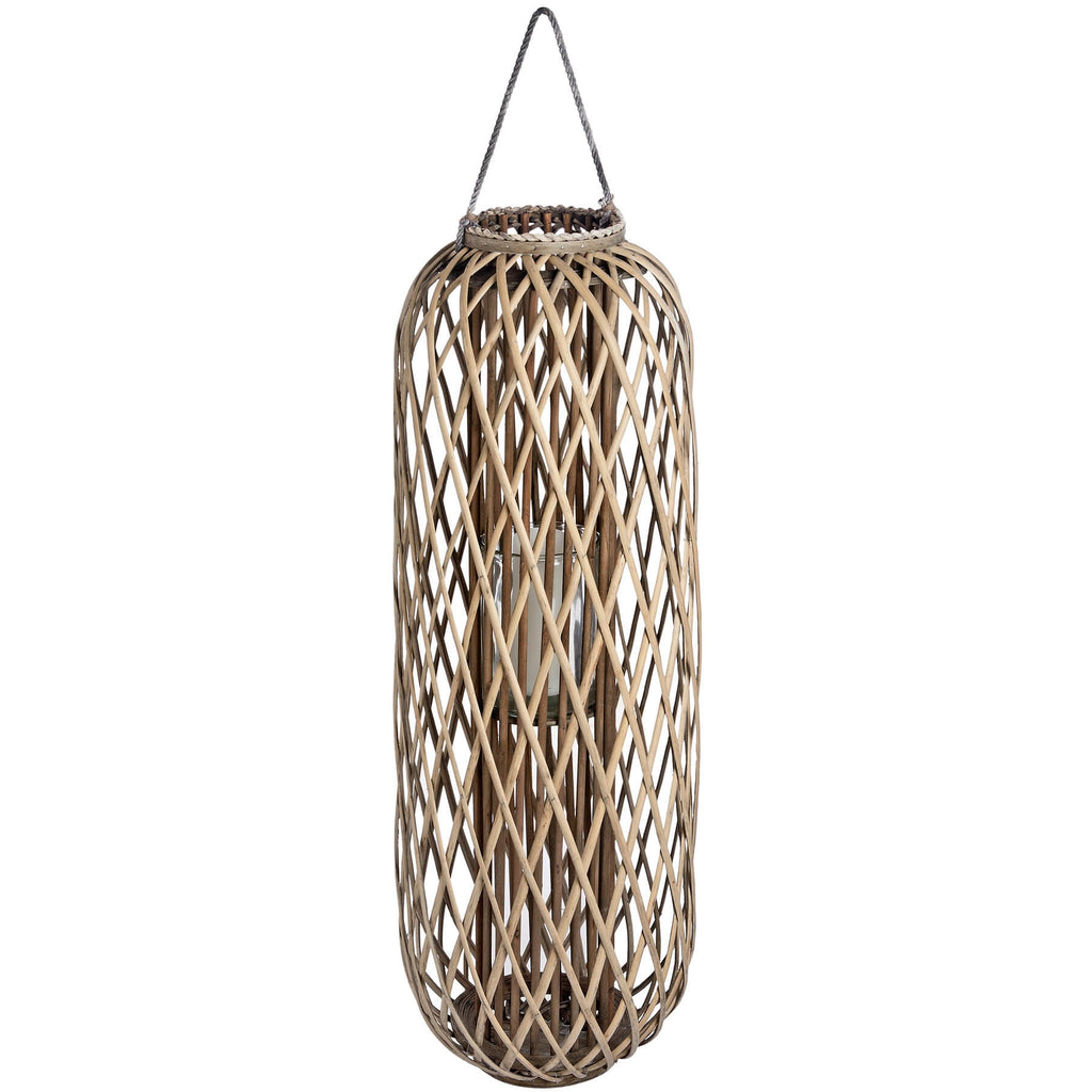 Handwoven wicker lantern with intricate rattan weave, creating warm light patterns, rustic brown home decor. by Sostter at brixbailey.com