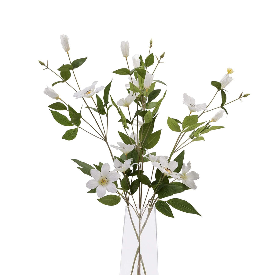 White artificial clematis stems with green foliage, hyper-realistic plastic flowers for everlasting garden decor by Sostter at brixbailey.com