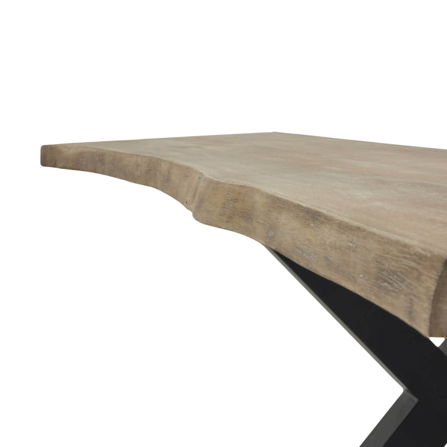 Live edge acacia dining table with natural grain, light finish, and black metal detailing in organic modern style. by Sostter at brixbailey.com