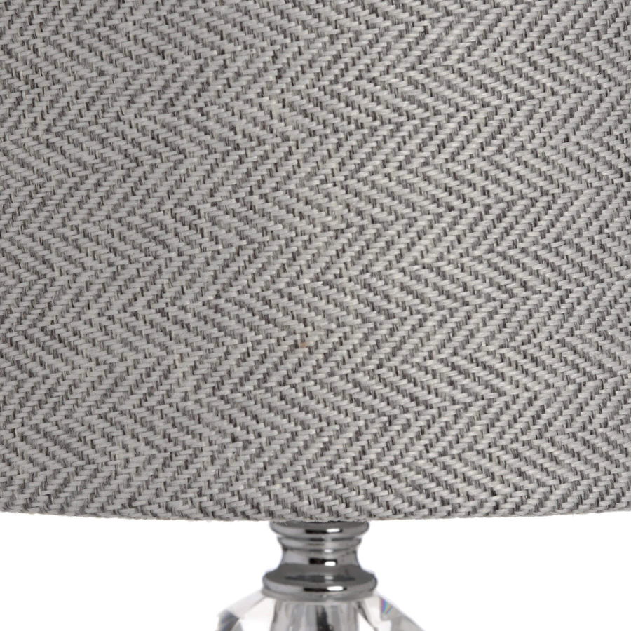 Handcrafted chrome and glass table lamp with grey herringbone shade for modern or traditional interiors by Hill Interiors at brixbailey.com