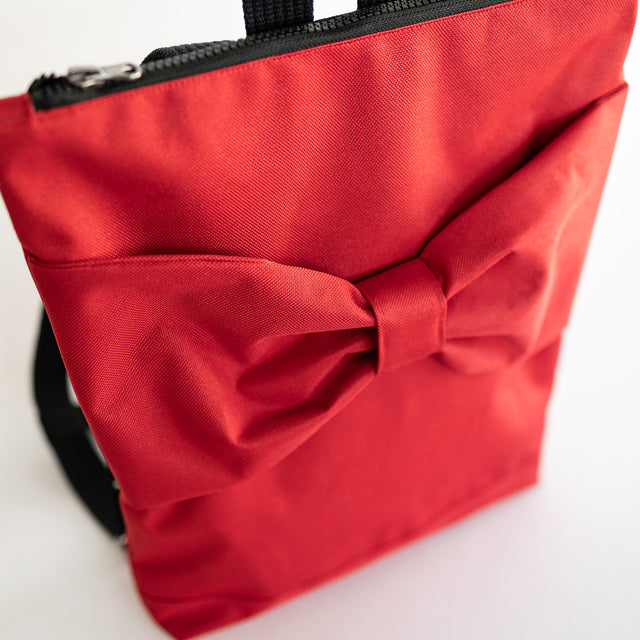 Red Bow Backpack for Kids – Waterproof & Playful Design by Muni at www.brixbailey.com