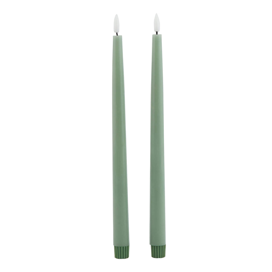 Sage green LED candle with realistic wax texture and flickering glow, 25 cm tall, flame-free ambiance for home decor. by Sostter at brixbailey.com