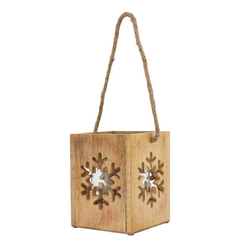 Handcrafted wooden snowflake tealight holder with intricate design, natural wood grain, casting warm holiday shadows. by Sostter at brixbailey.com