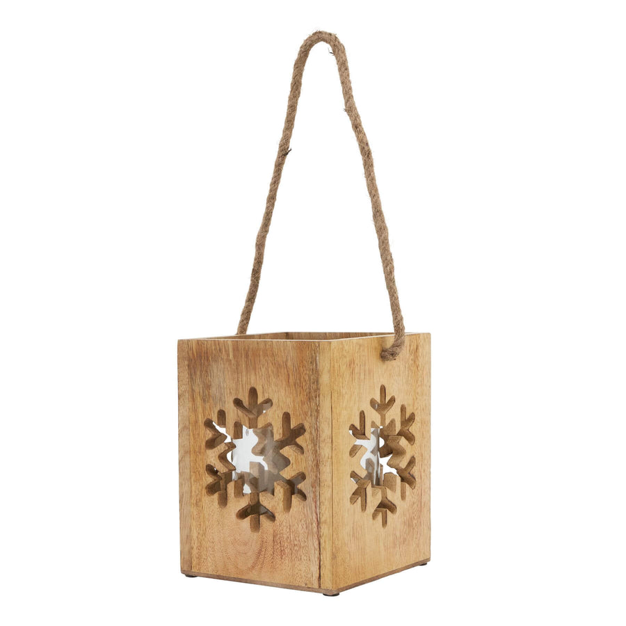 Handcrafted wooden snowflake tealight holder with intricate design, natural wood grain, casting warm holiday shadows. by Sostter at brixbailey.com