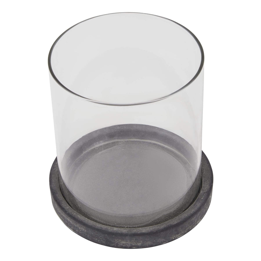 Grey ceramic hurricane lantern with Mediterranean coastal design, casting ambient light patterns, weathered finish. by Sostter at brixbailey.com
