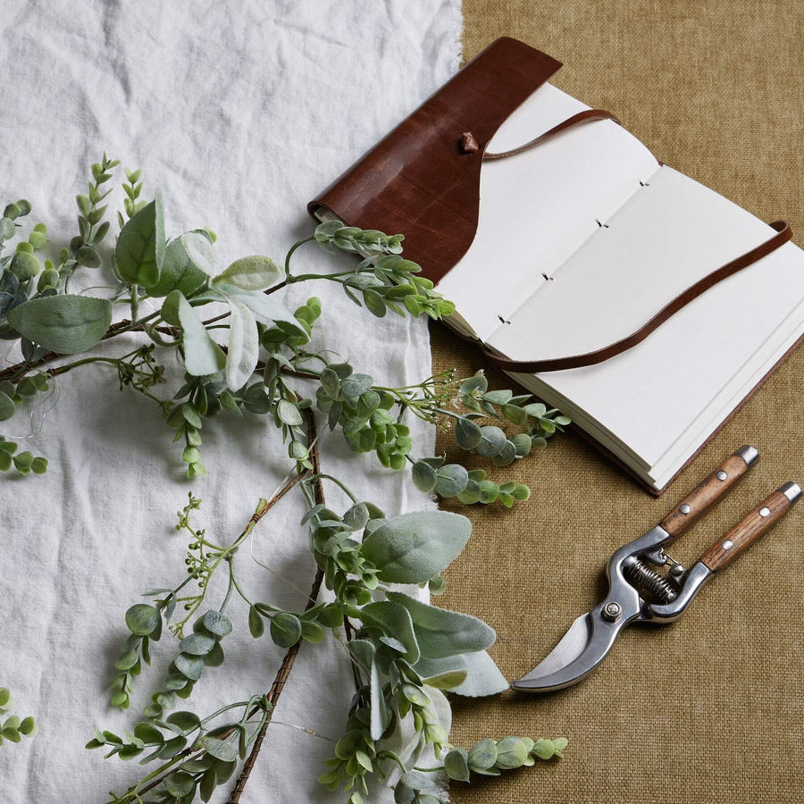 Frosted eucalyptus LED garland with silver accents, 5 feet long, battery-operated winter decor for mantels or staircases by Sostter at brixbailey.com