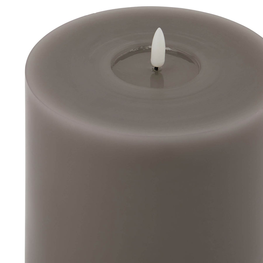 Grey LED wax candle with realistic melt effect and flickering light for flame-free ambiance by Sostter at brixbailey.com