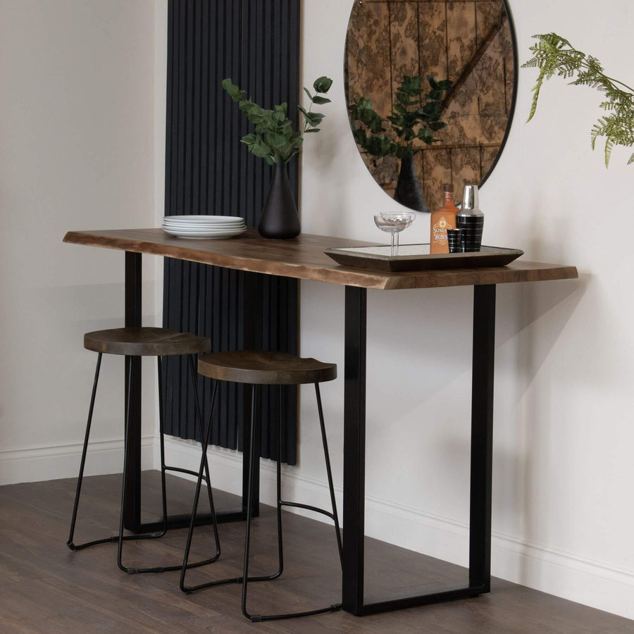 Live edge acacia wood bar table with black metal base, showcasing natural grain and rustic-industrial style. by Sostter at brixbailey.com