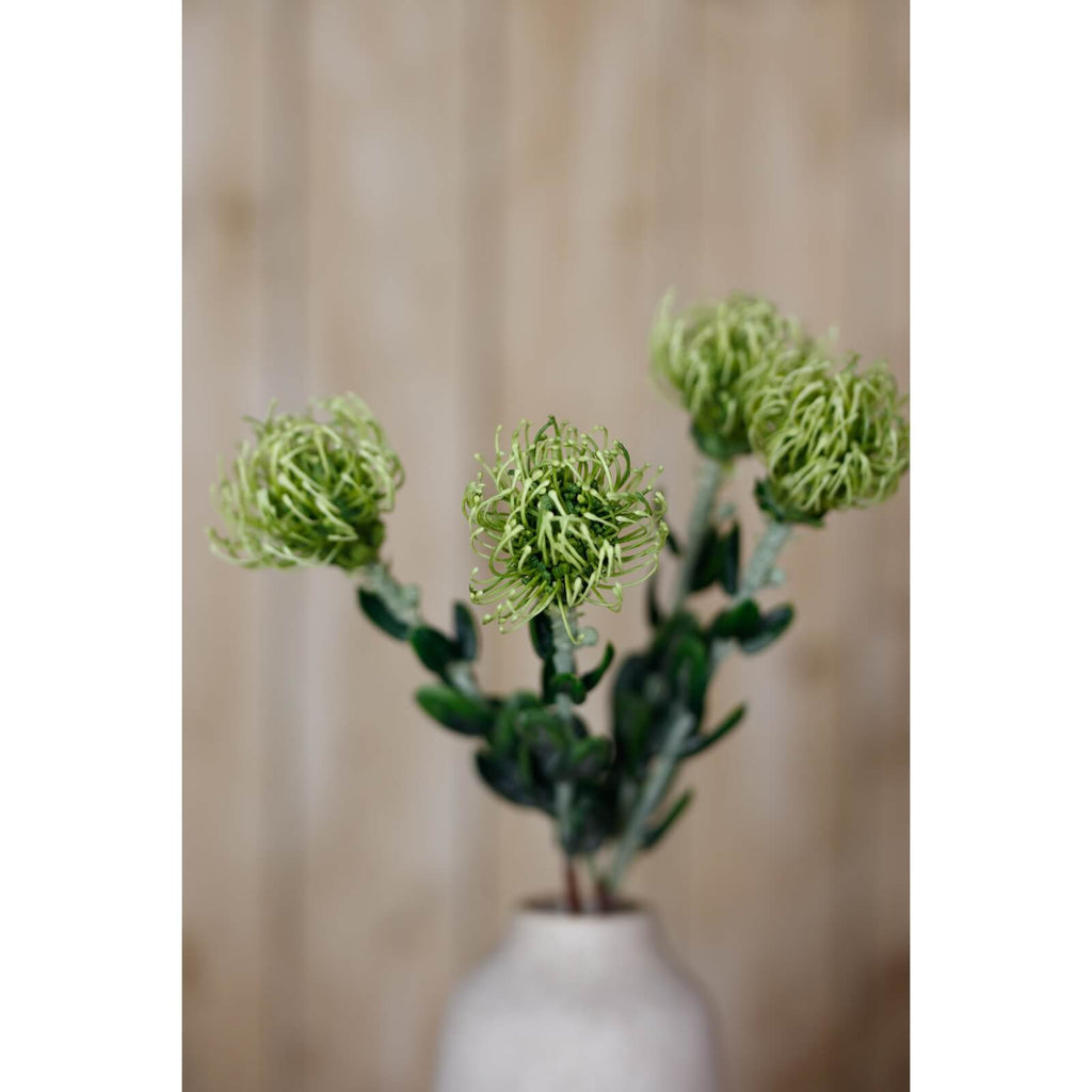 Lifelike pincushion protea spray with spherical blooms and lush green foliage, premium plastic faux botanical decor by Sostter at brixbailey.com