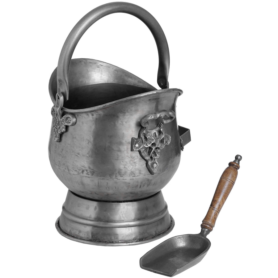 Handcrafted antique pewter coal bucket and shovel set with floral embossing, rustic brown patina, and curved wooden handle. by Sostter at brixbailey.com