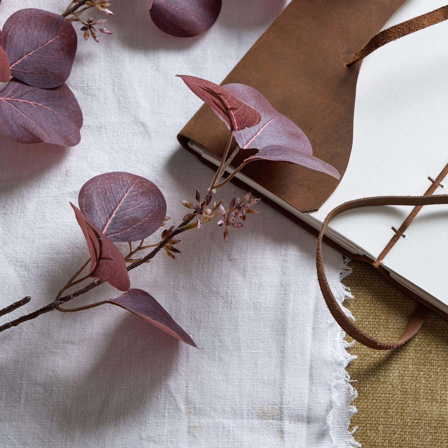 Burgundy berried eucalyptus stem with lifelike plastic leaves and berries, perfect for seasonal home decor by Sostter at brixbailey.com