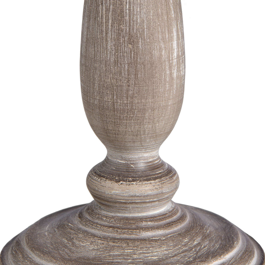Rustic table lamp with whitewashed wood base and natural linen shade, emitting warm ambient light for cozy home decor. by Hill Interiors at brixbailey.com