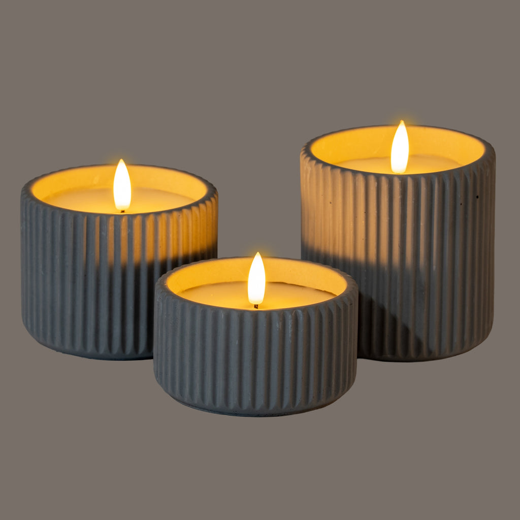 elegant grey ribbed led candle casting a soft, refined glow in a sophisticated home setting