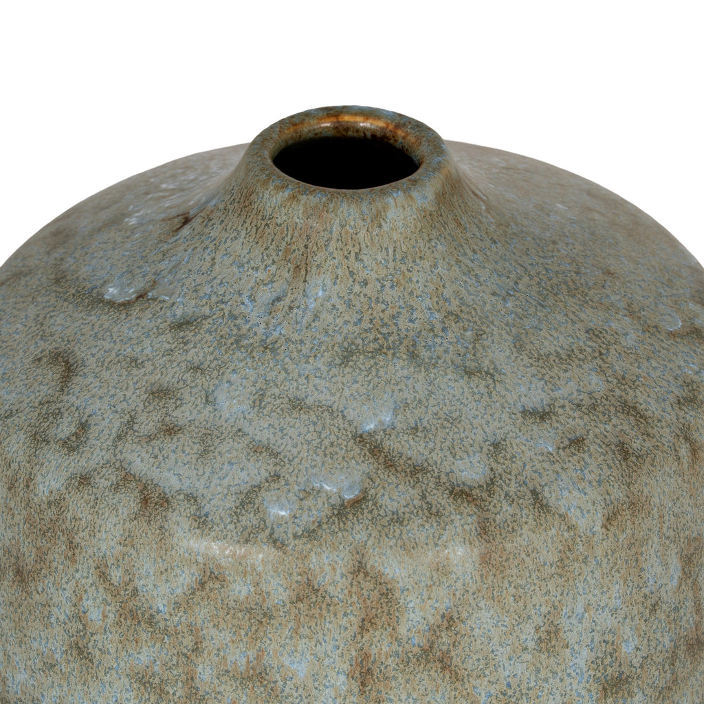 a playful grey ceramic bottle vase on a sunny windowsill, casting a soft shadow