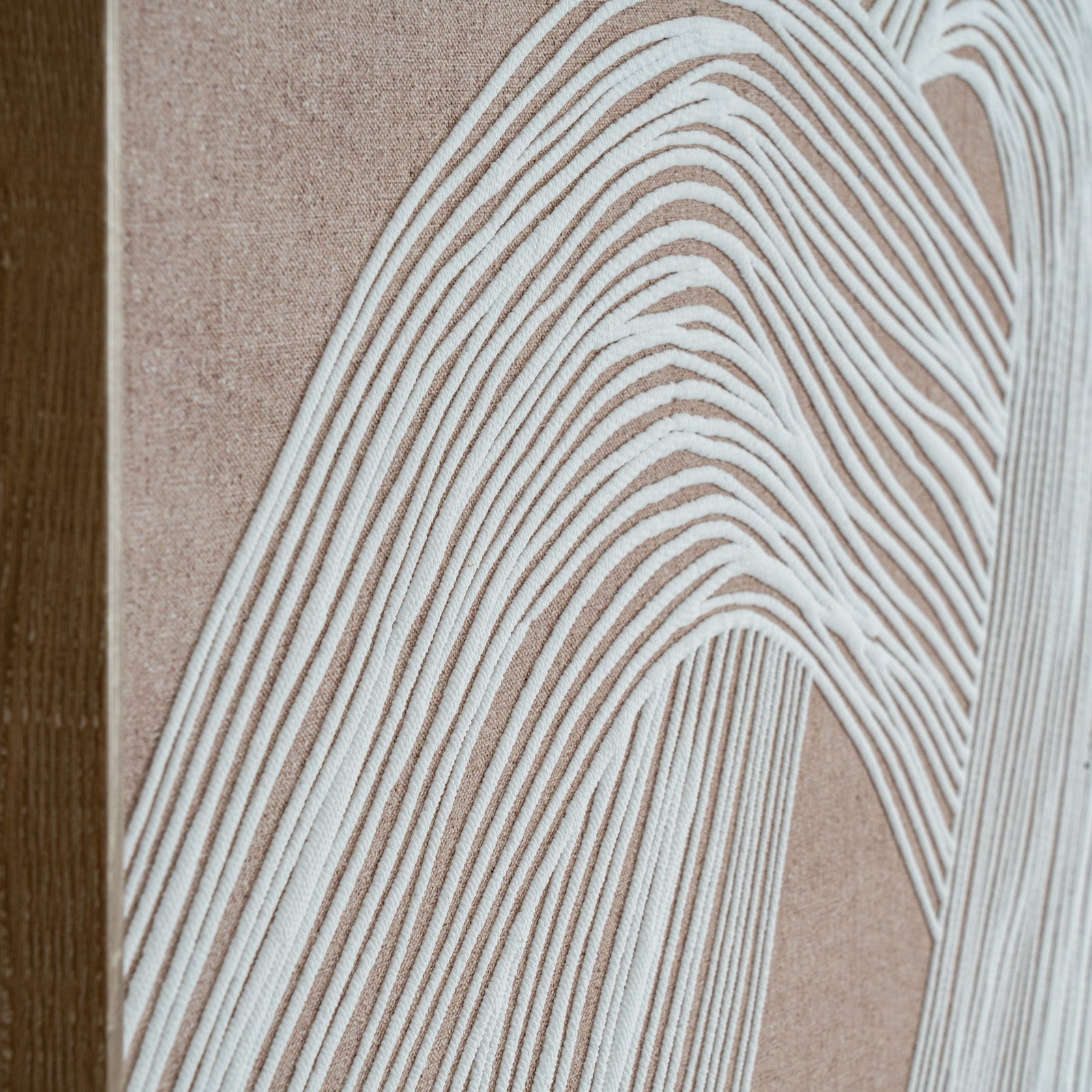 elegant framed minimalist line art print in a warm brown wood frame, showcased in a refined interior setting